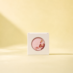 A boxed Joy bath bomb standing on a warm yellow background with soft shadow.