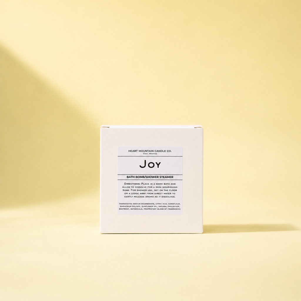 A white box labeled 'Joy' standing upright on a pale yellow background.