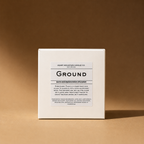 A white box labeled 'Ground' bath bomb/shower steamer on a brown background.