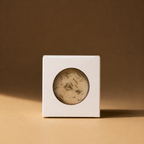 A boxed Ground bath bomb with a tan window on a brown background.