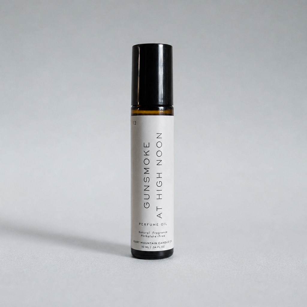 A Gunsmoke at High Noon perfume oil rollerball bottle on a light gray background.