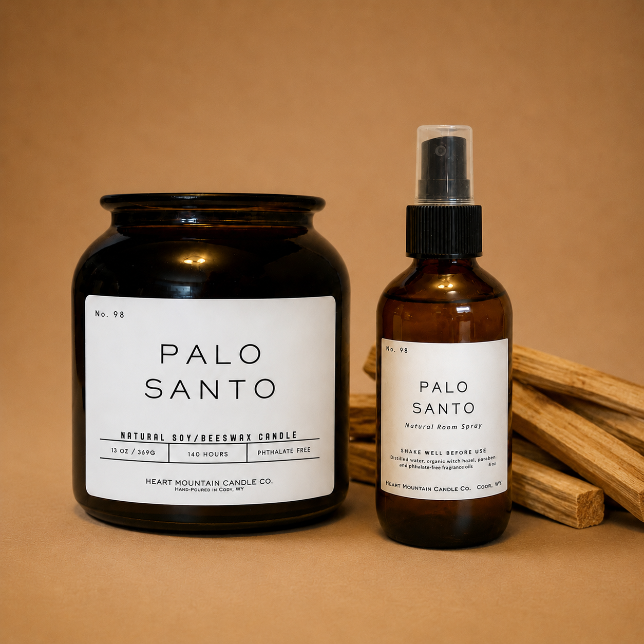 A Palo Santo candle jar and room spray bottle, styled with palo santo wood sticks.