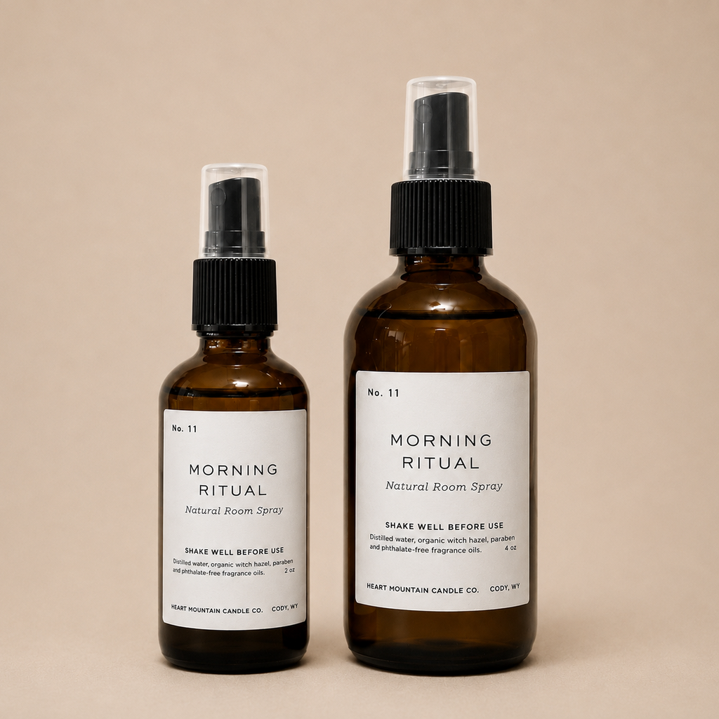 Two Morning Ritual room spray bottles in different sizes on a beige background.