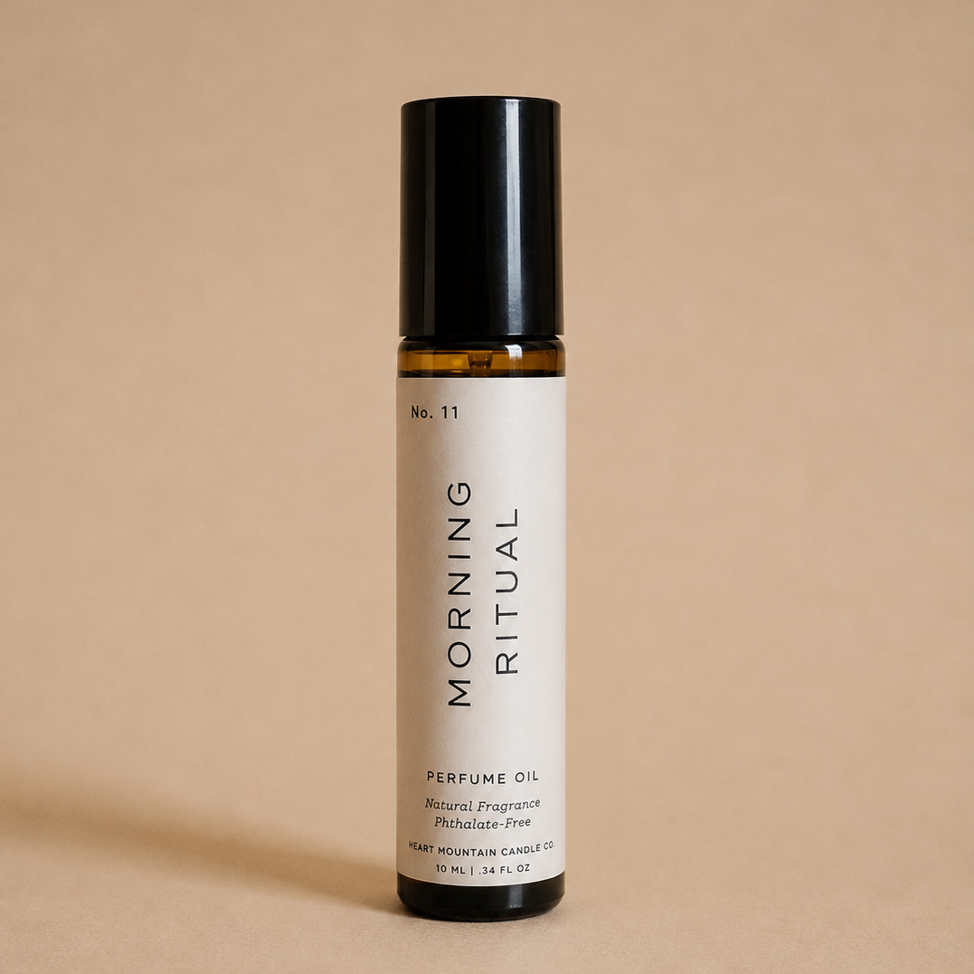 A Morning Ritual perfume oil rollerball bottle on a beige background.