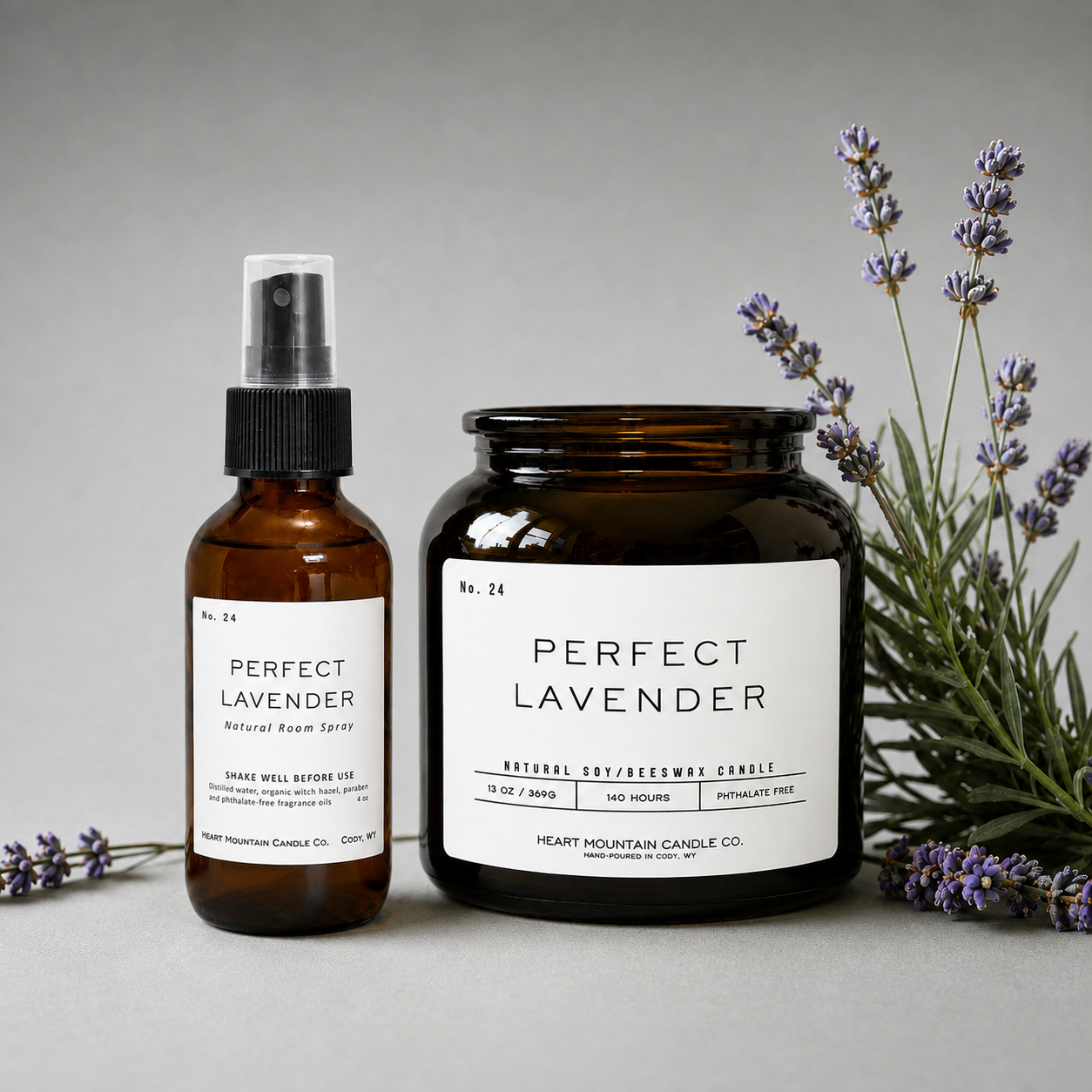A Perfect Lavender room spray bottle and candle jar, styled with fresh lavender sprigs.