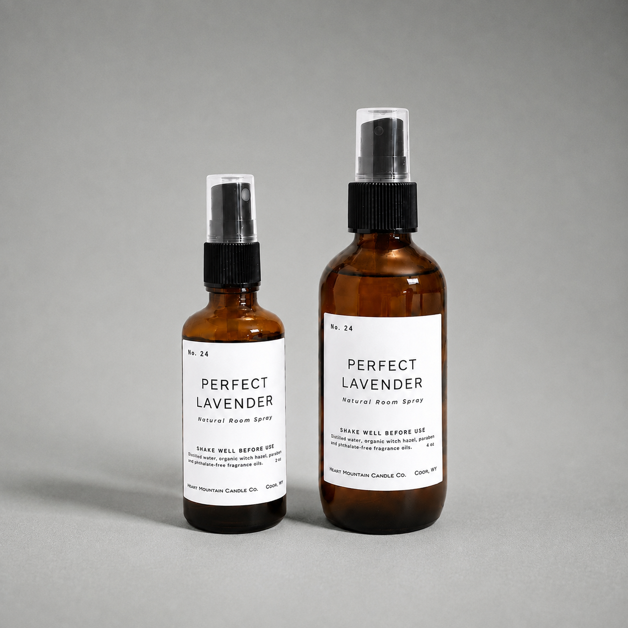 Two Perfect Lavender room spray bottles in different sizes on a gray background.
