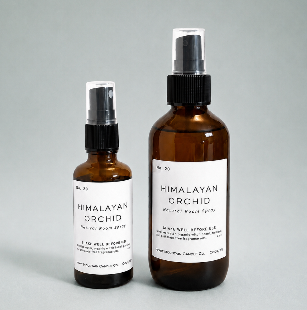 Two Himalayan Orchid room spray bottles in different sizes on a light gray background.