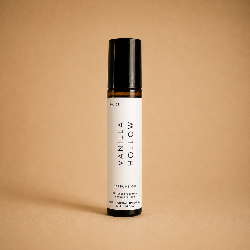 Amber glass Vanilla Hollow rollerball perfume oil with a black cap on a beige background.