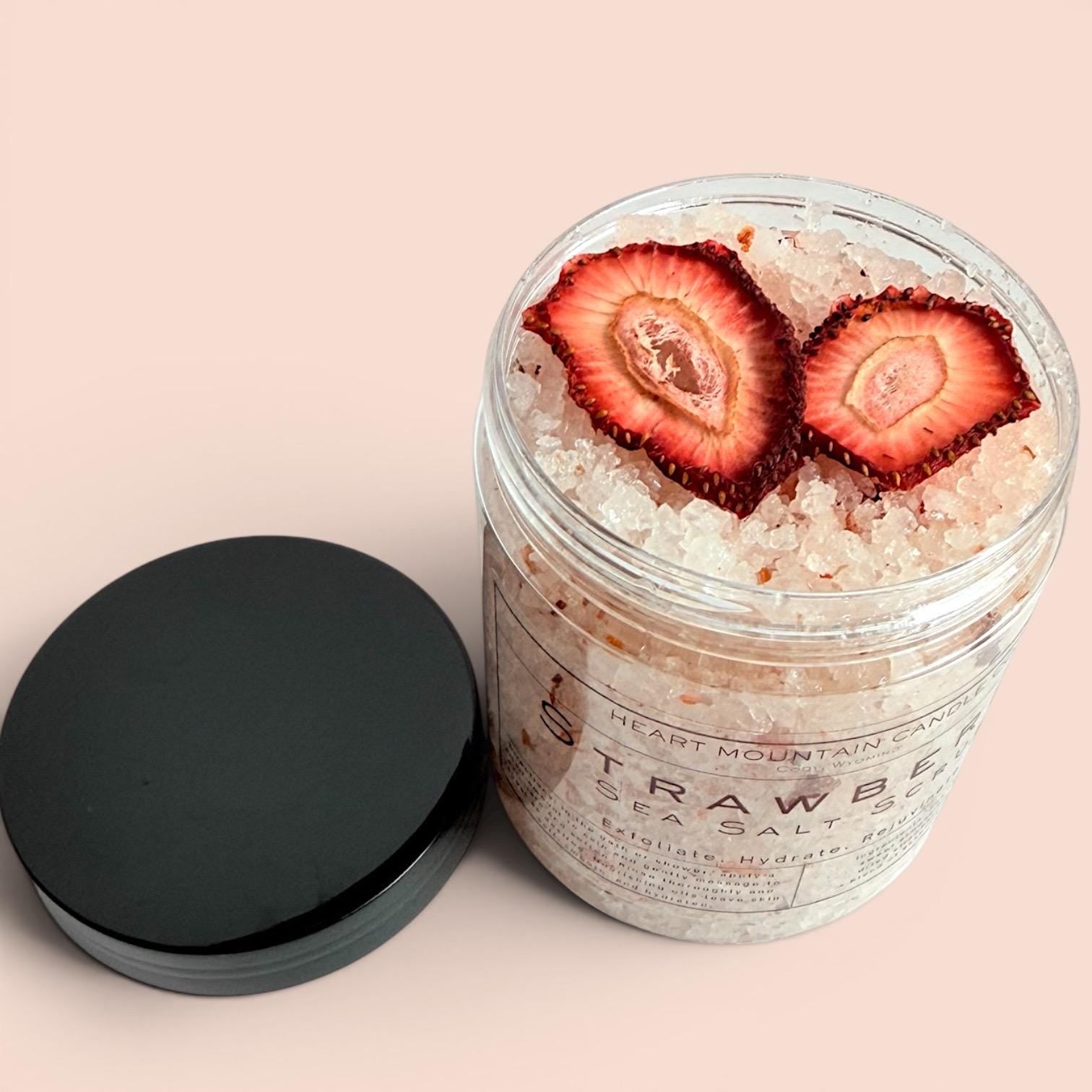 strawberry exfoliating scrub sea salt body polish natural skincare hydrating body scrub self care spa gift glowing skin exfoliator coarse salt scrub body treatment almond oil coconut oil sunflower oil nourishing scrub skin smoothing exfoliation strawberry skincare body care routine spa gift idea bath and shower scrub